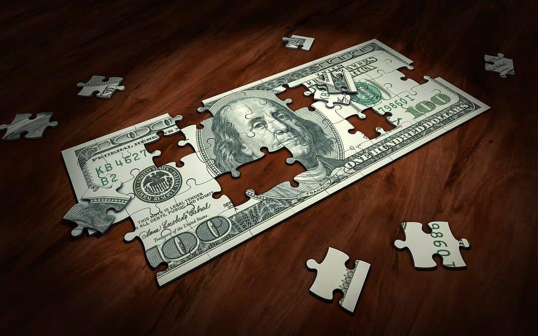 One Hundred dollar Bill Puzzle with scattered pieces